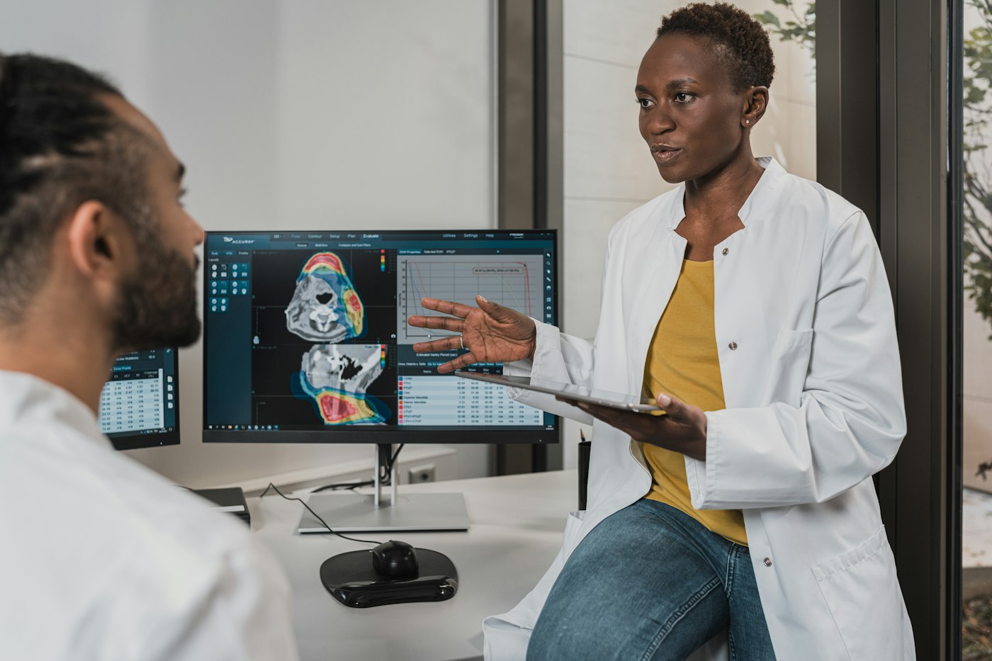 Two clinicians reviewing a medical scan together