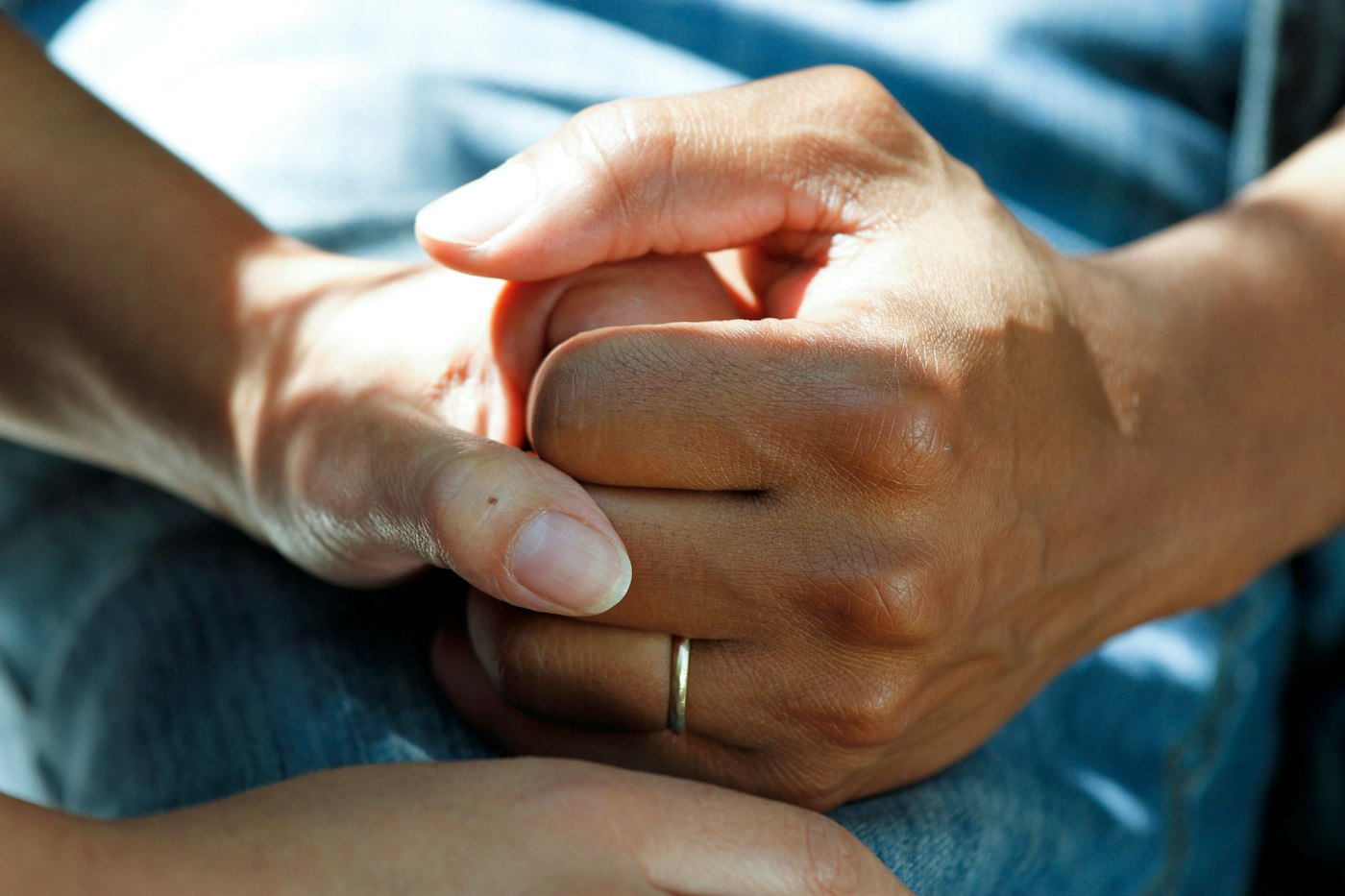 Two people holding hands in warm daylight