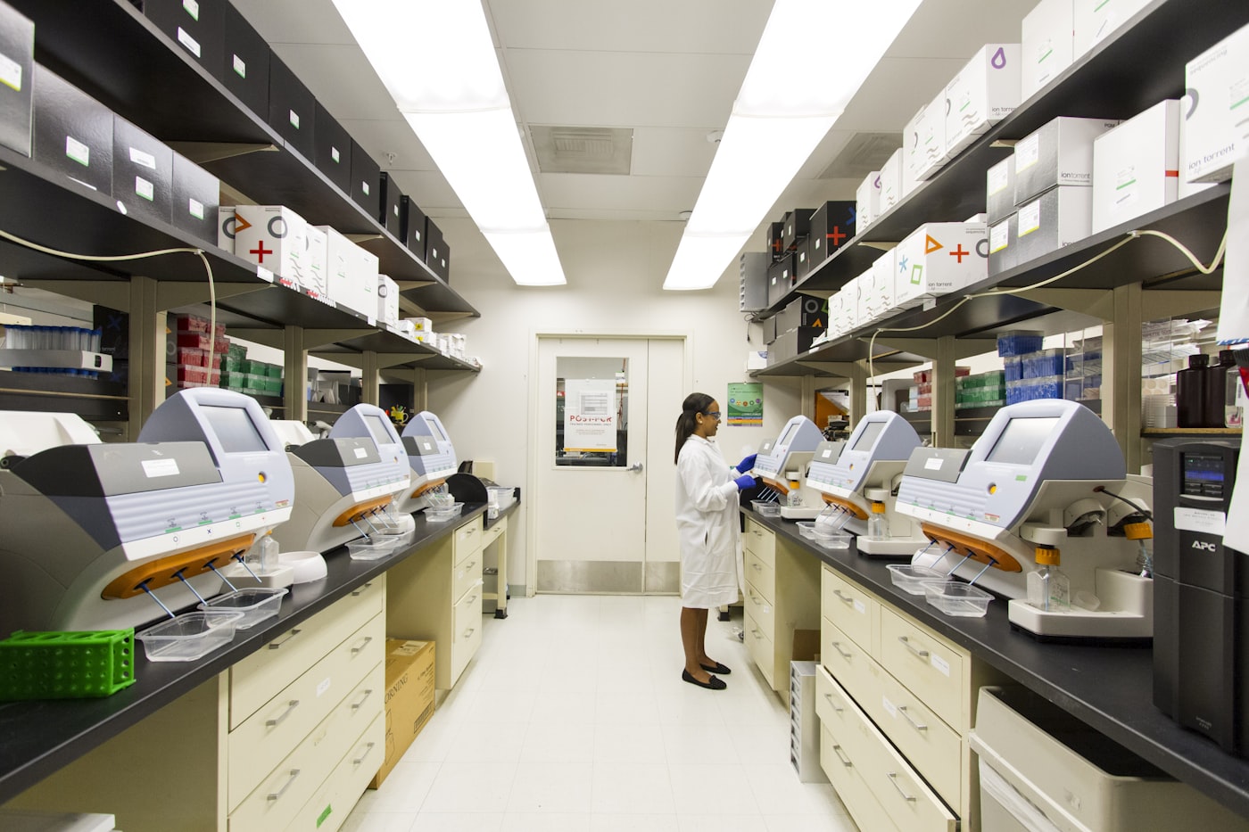 Scientist working among laboratory analysers